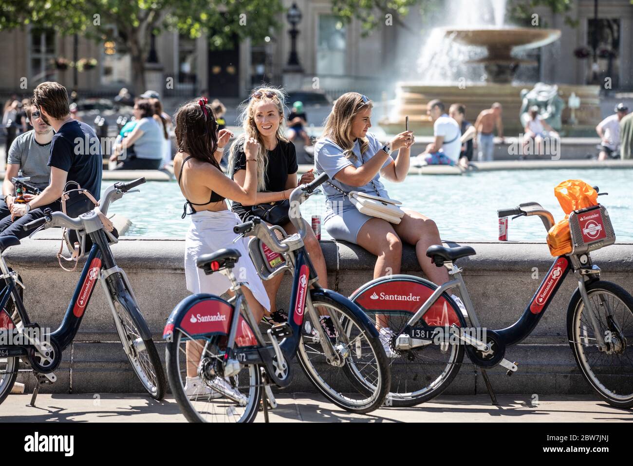 London, UK. 30th May, 2020. Tourists and Londoner's enjoy the sunshine whilst sitting at the fountains in Trafalgar Square, London, UK. 30th May, 2020. Trafalgar Square London, England, UK Credit: Clickpics/Alamy Live News Stock Photo