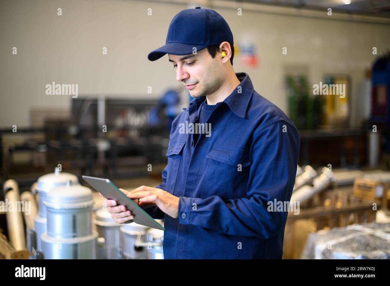 Portrait af an engineer using a tablet in a facility Stock Photo