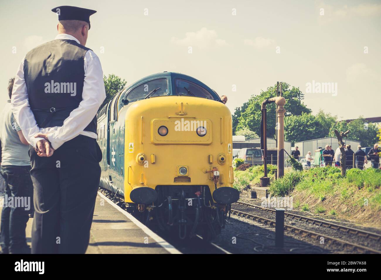 Close up of vintage diesel locomotive 55019 Royal Highland Fusilier, Class 55, being admired by railway worker on platform, Severn Valley Railway, UK. Stock Photo