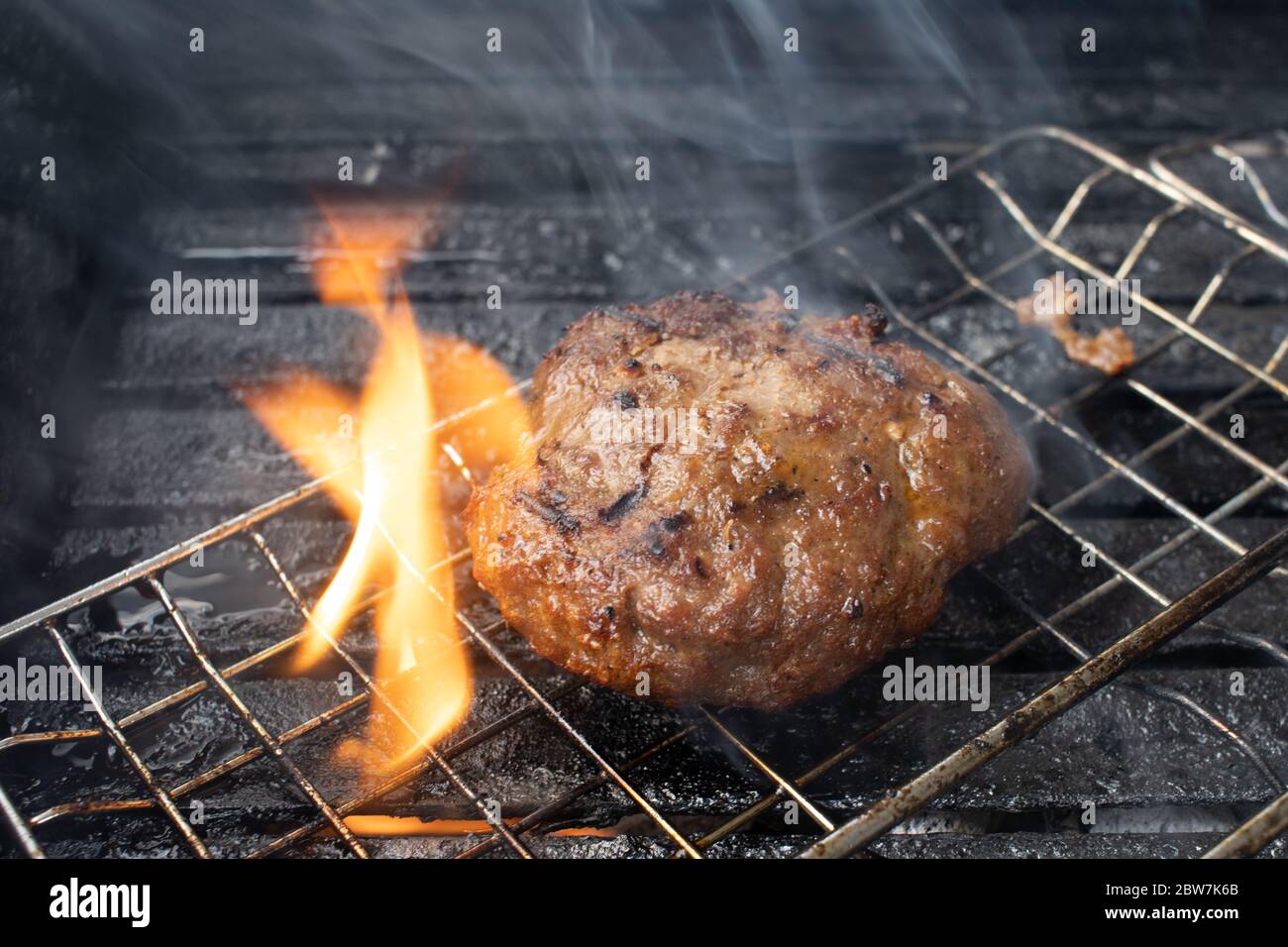 cooking burgers on hot grill with flames Stock Photo Alamy