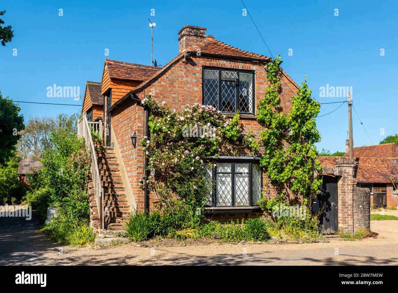 Converted farm building with outside steps in the pretty hamlet of Brewhurst, Loxwood, West Sussex, UK Stock Photo