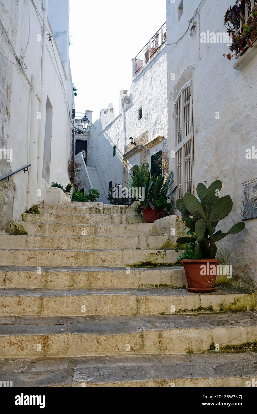 Typical narrow little street with a lots of stairs in Ostuni, La Citta Bianca. Ostuni. Puglia, Italy Stock Photo