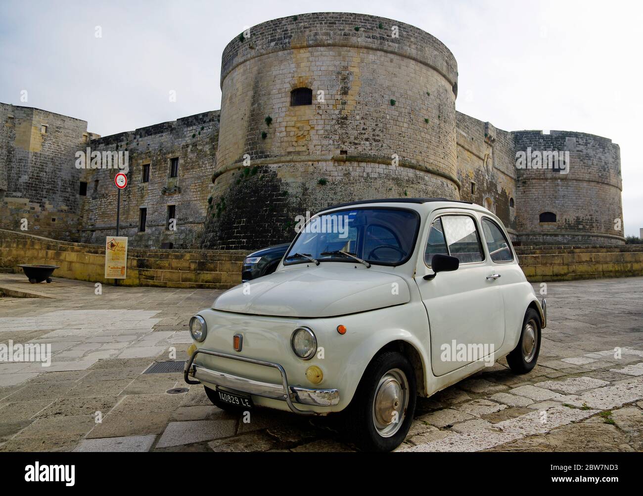 OTRANTO, APULIA ,ITALY - MARCH 30, 2018: Classic Fiat Cinquecento in front of Medieval Aragonese Castle in Otranto, Apulia, Italy Stock Photo