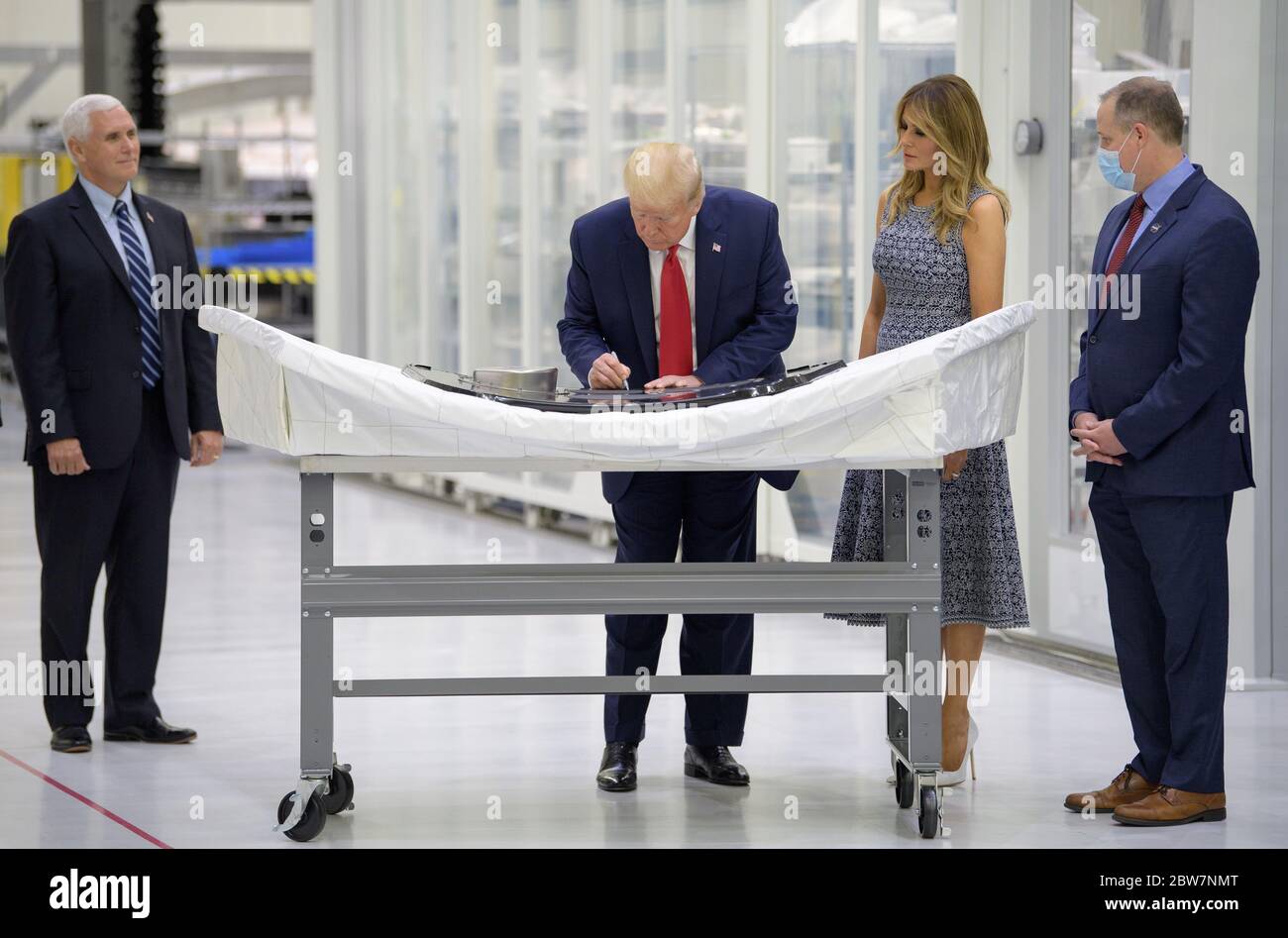 U.S. President Donald Trump signs an Orion capsule hatch that will be used for the Artemis II mission as Vice President Mike Pence, First Lady Melania Trump, and NASA Administrator Jim Bridenstine look on during a tour of the Neil Armstrong Operations and Checkout Building May 27, 2020 in Cape Canaveral, Florida. Stock Photo