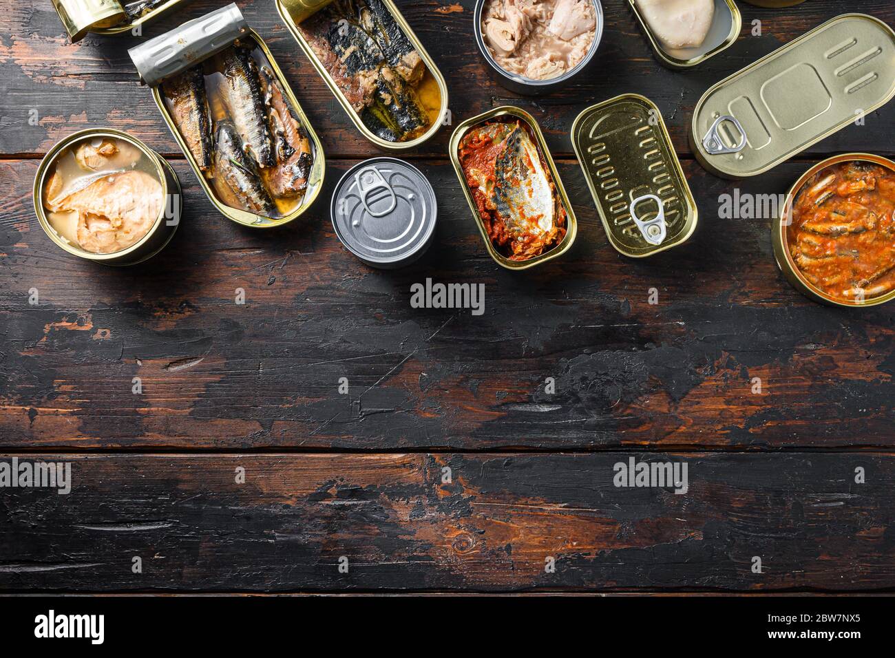 Conserves of canned fish with different types of seafood, opened and closed cans with Saury