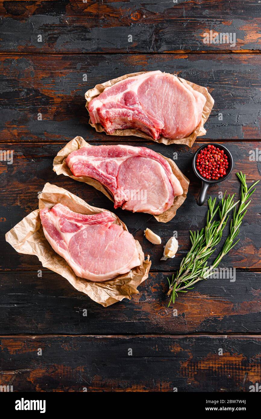 barbecue pork portion set over old rustic dark wood table with herbs