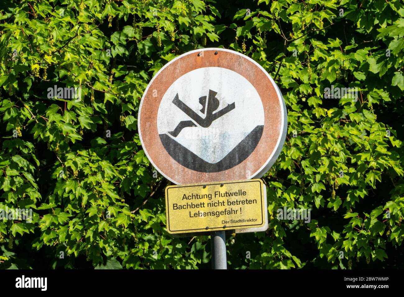 Germany,Bergheim Sieg, Warning sign 'Attention flood wave, don't enter riverbed, danger of life'' Stock Photo