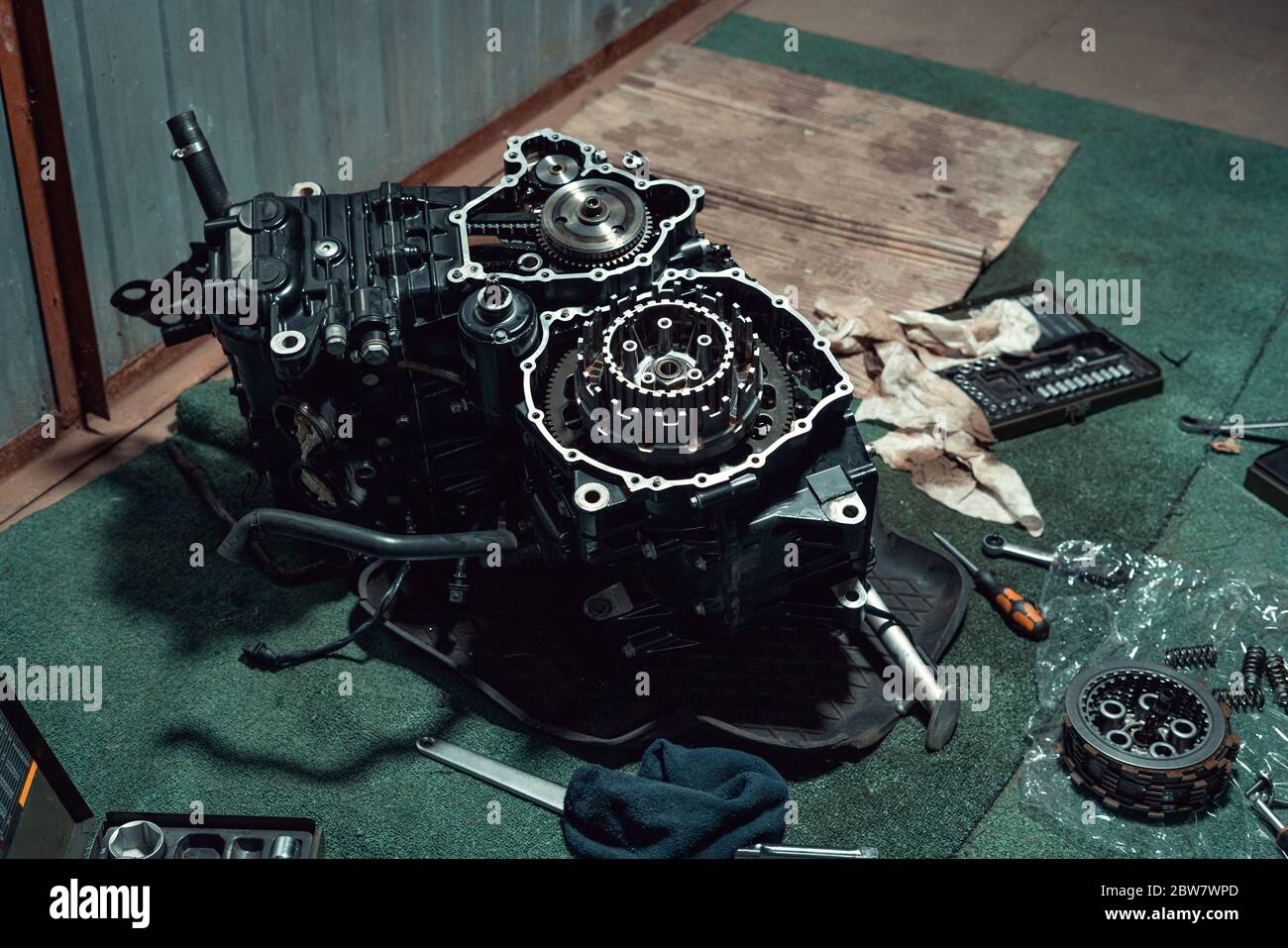 Disassembled fast motorcycle engine with visible clutch. Sixteen valves and four cylinder. Stock Photo
