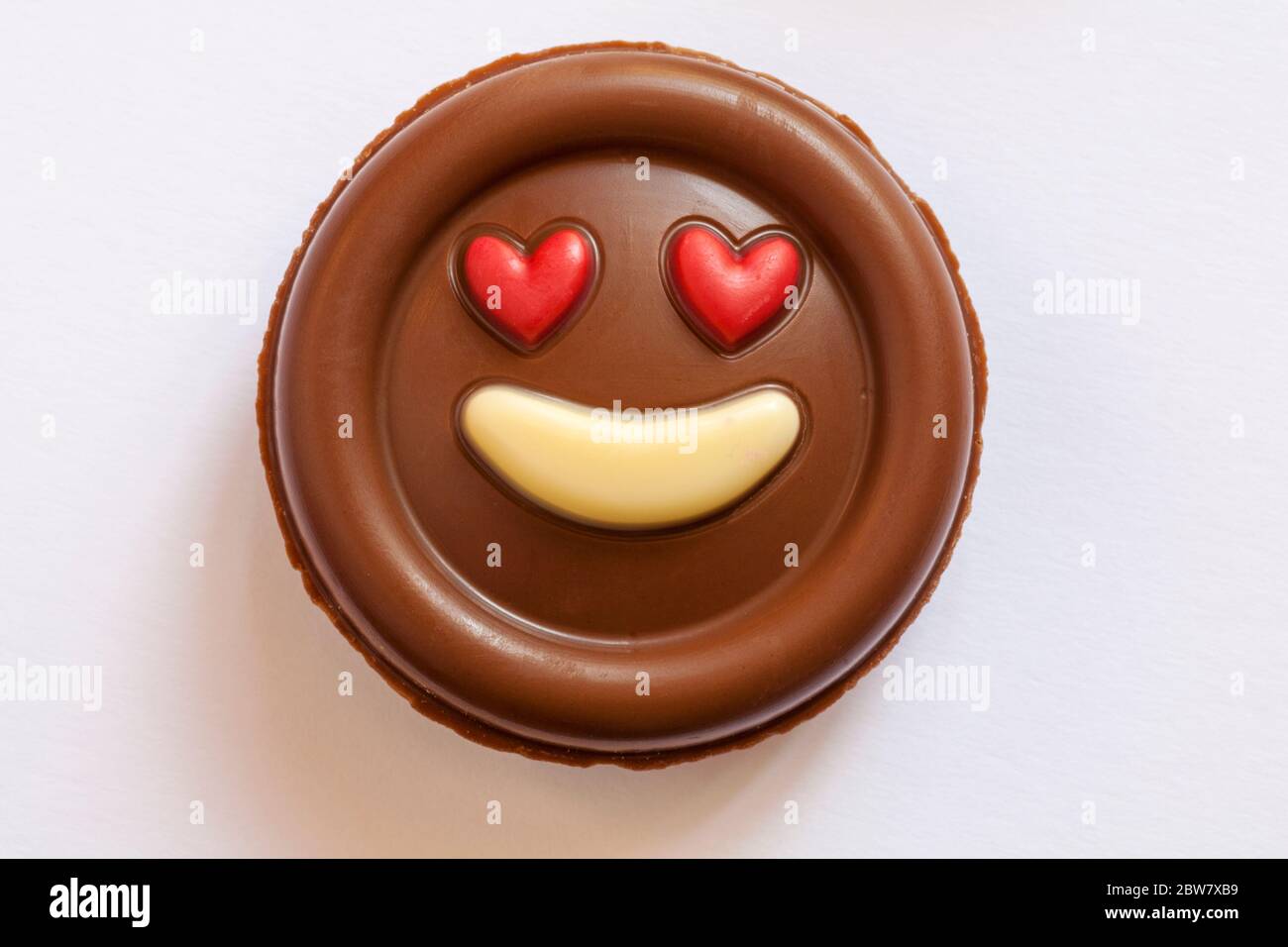 M&S Milk Chocolate Emotions - put a smile on your face chocolate removed from pack isolated on white background - red heart eyes love emoji emoticon Stock Photo