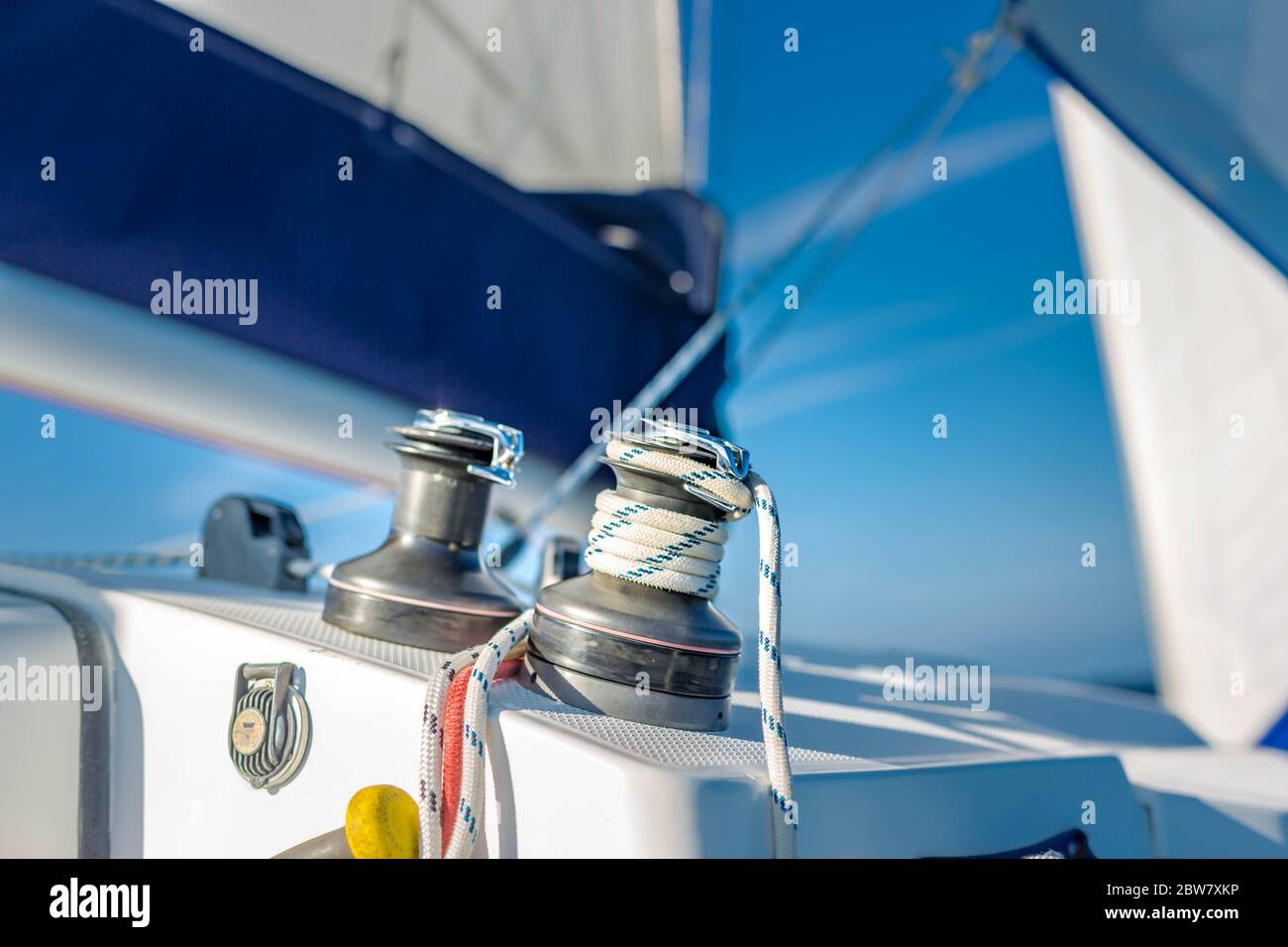 Sailboat winch and rope yacht detail. Yachting, winch with ropes on a sailboat while sailing Stock Photo