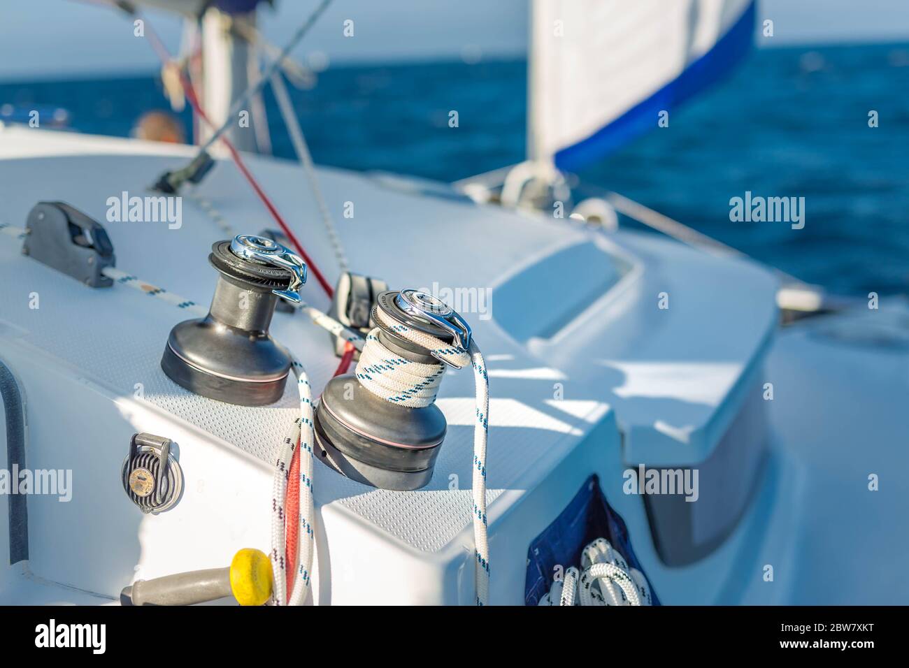Sailboat winch and rope yacht detail. Yachting, winch with ropes on a sailboat while sailing Stock Photo