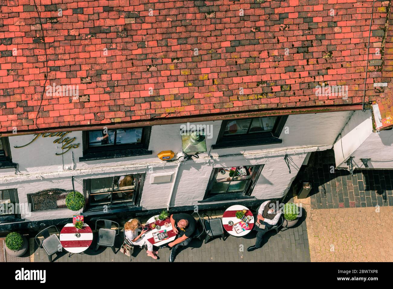St Albans, England: Rooftops of the historic city centre and outside tables of The Fleur de Lys (The Snug) bar seen from the Clock Tower, in summer. Stock Photo