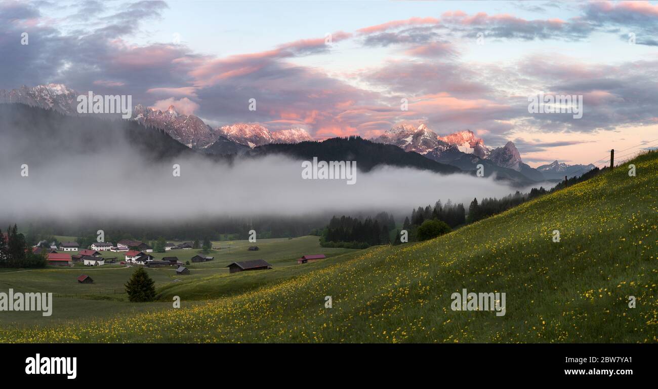 Zugspitze and Alpsitze mountains panorama at foggy Sunrise from Gerold village Stock Photo