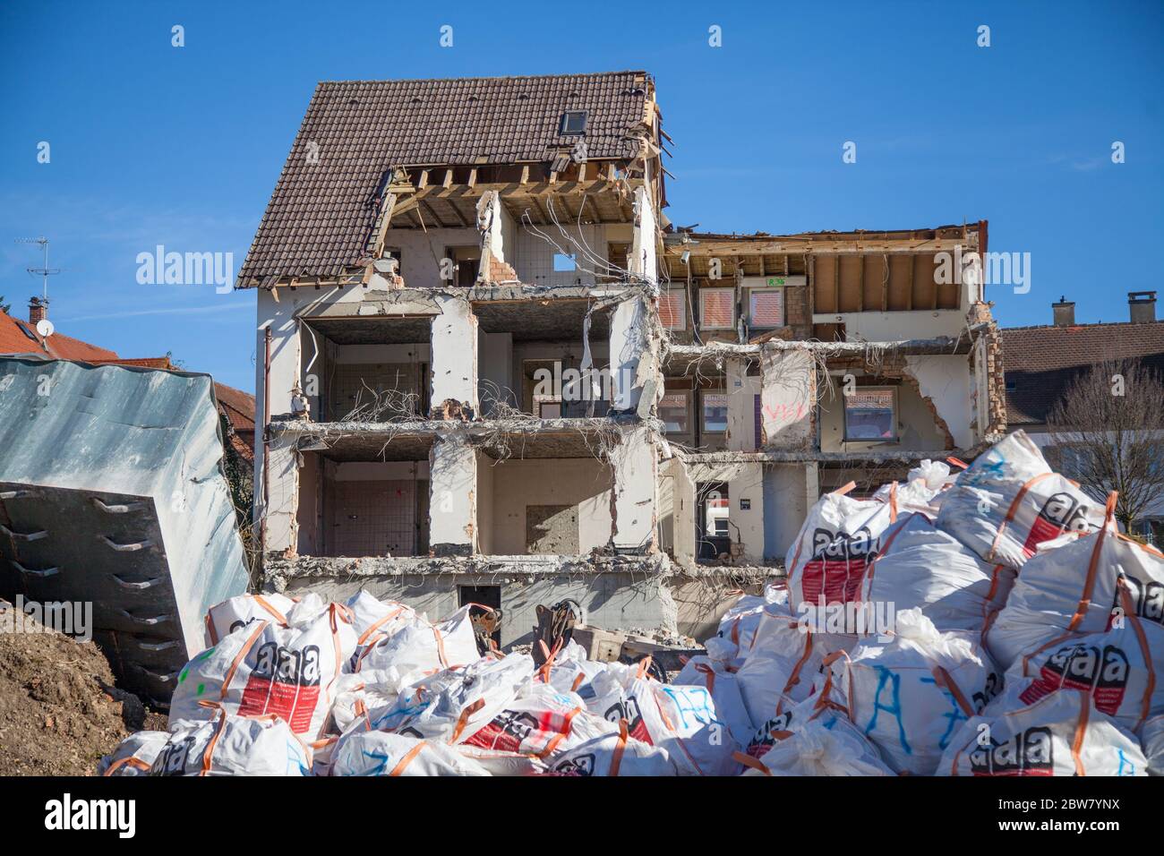 Demolition of a house with asbestos waste in foreground Stock Photo Alamy