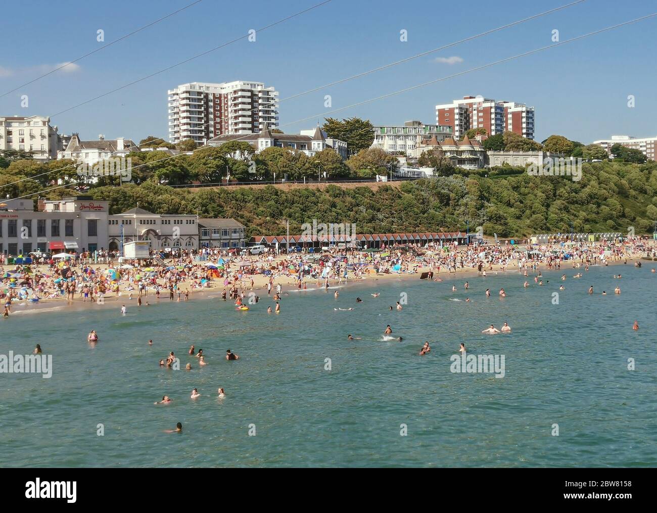 Bournemouth, UK. 30th May 2020. Bournemouth, UK.  Thousands of people descend on Bournemouth beach, many ignoring social distancing rules and crowding the beach and sea. Credit: Thomas Faull/Alamy Live News Stock Photo