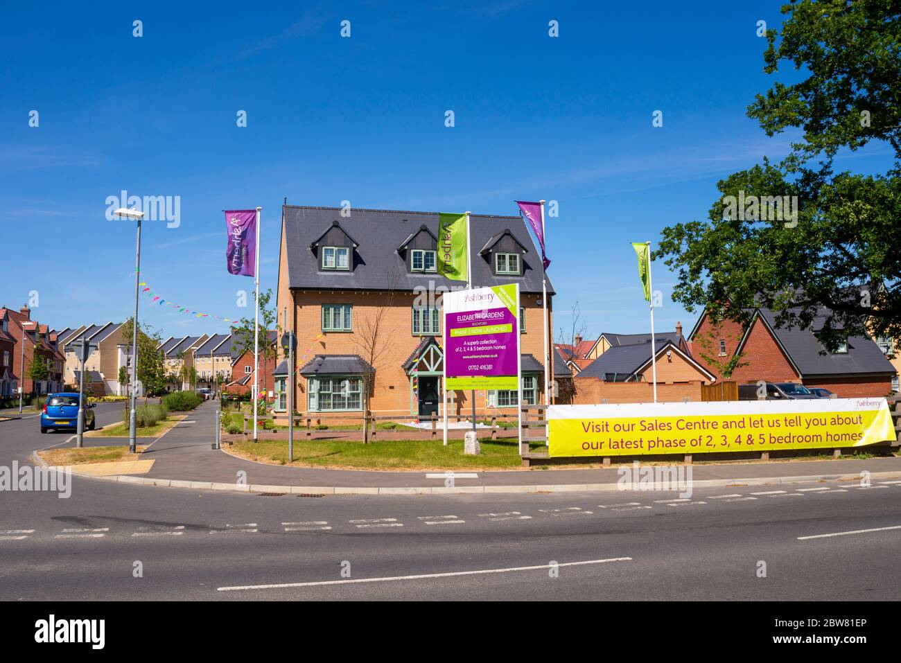 Ashberry Homes estate, Elizabeth Gardens in Rochford, Southend, Essex, UK. New homes for sale. Show home with advertising banner and sign. Bunting Stock Photo