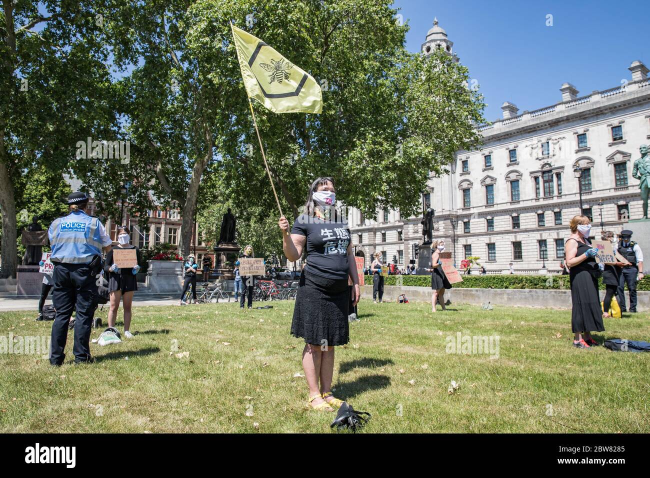 Parliament Square, London, UK. 30 May 2020. A few hundred environmental campaigners from Extinction Rebellion demonstrate peacefully in Parliament Square. Protesters hold placards, demand decisive action from the UK Government on the global environmental crisis. Activists are standing and maintain appropriate social distancing. Police questions individual campaigners prompting them to move on; some are body searched and arrests follow for breach of Covid-19 regulations. Stock Photo