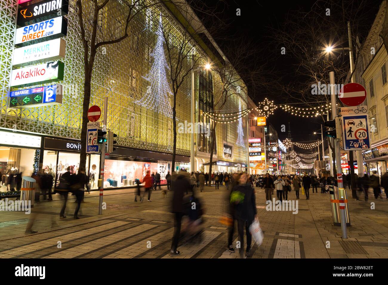 VIENNA, AUSTRIA - 4TH DECEMBER 2015: A view along Mariahilferstrasse at night showing the Christmas atmosphere. Lots of people can be seen. Stock Photo