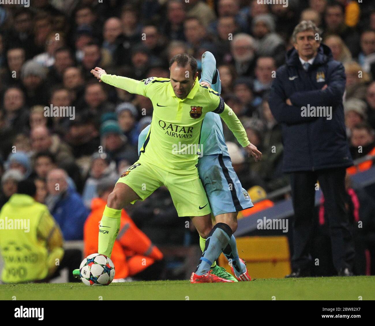 MANCHESTER, ENGLAND - Andres Iniesta of Barcelona battles with David Silva of Manchester City during the UEFA Champions League Round of 16 1st Leg between Manchester City and FC Barcelona at the Etihad Stadium, Manchester on Tuesday 24th February 2015 (Credit: Mark Fletcher | MI News) Stock Photo