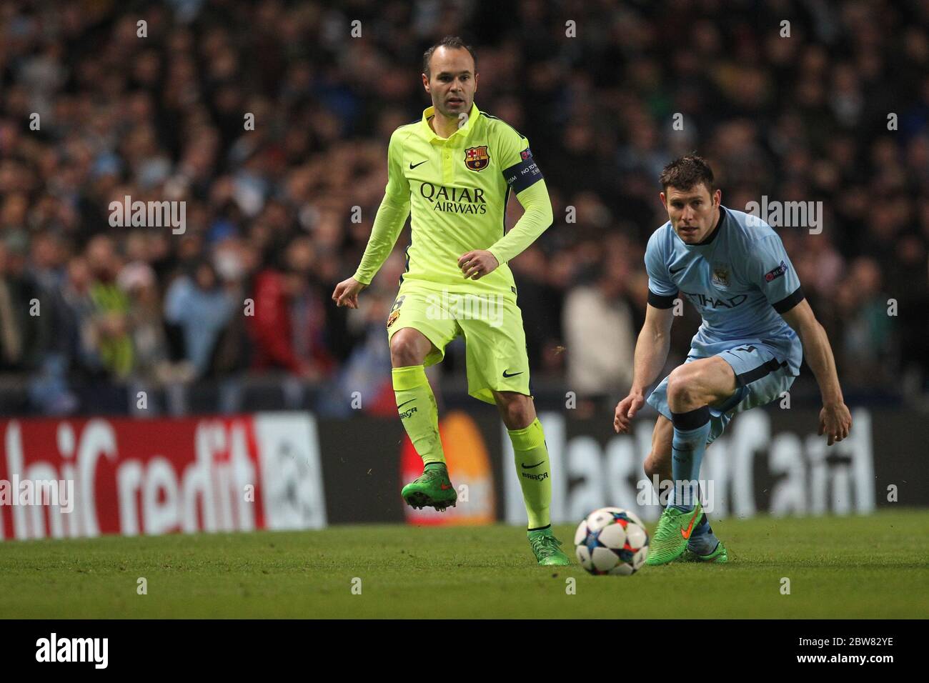 MANCHESTER, ENGLAND - Andres Iniesta of Barcelona and James Milner of Manchester City during the UEFA Champions League Round of 16 1st Leg between Manchester City and FC Barcelona at the Etihad Stadium, Manchester on Tuesday 24th February 2015 (Credit: Mark Fletcher | MI News) Stock Photo