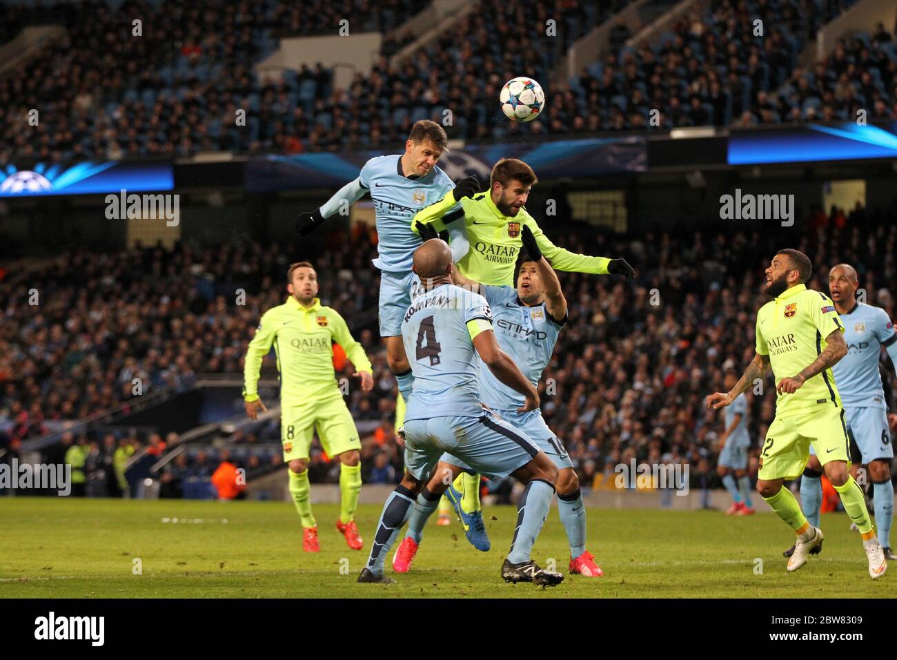 MANCHESTER, ENGLAND - Martin Demichelis of Manchester City gets above Gerard Pique and heads at goal during the UEFA Champions League Round of 16 1st Leg between Manchester City and FC Barcelona at the Etihad Stadium, Manchester on Tuesday 24th February 2015 (Credit: Mark Fletcher | MI News) Stock Photo