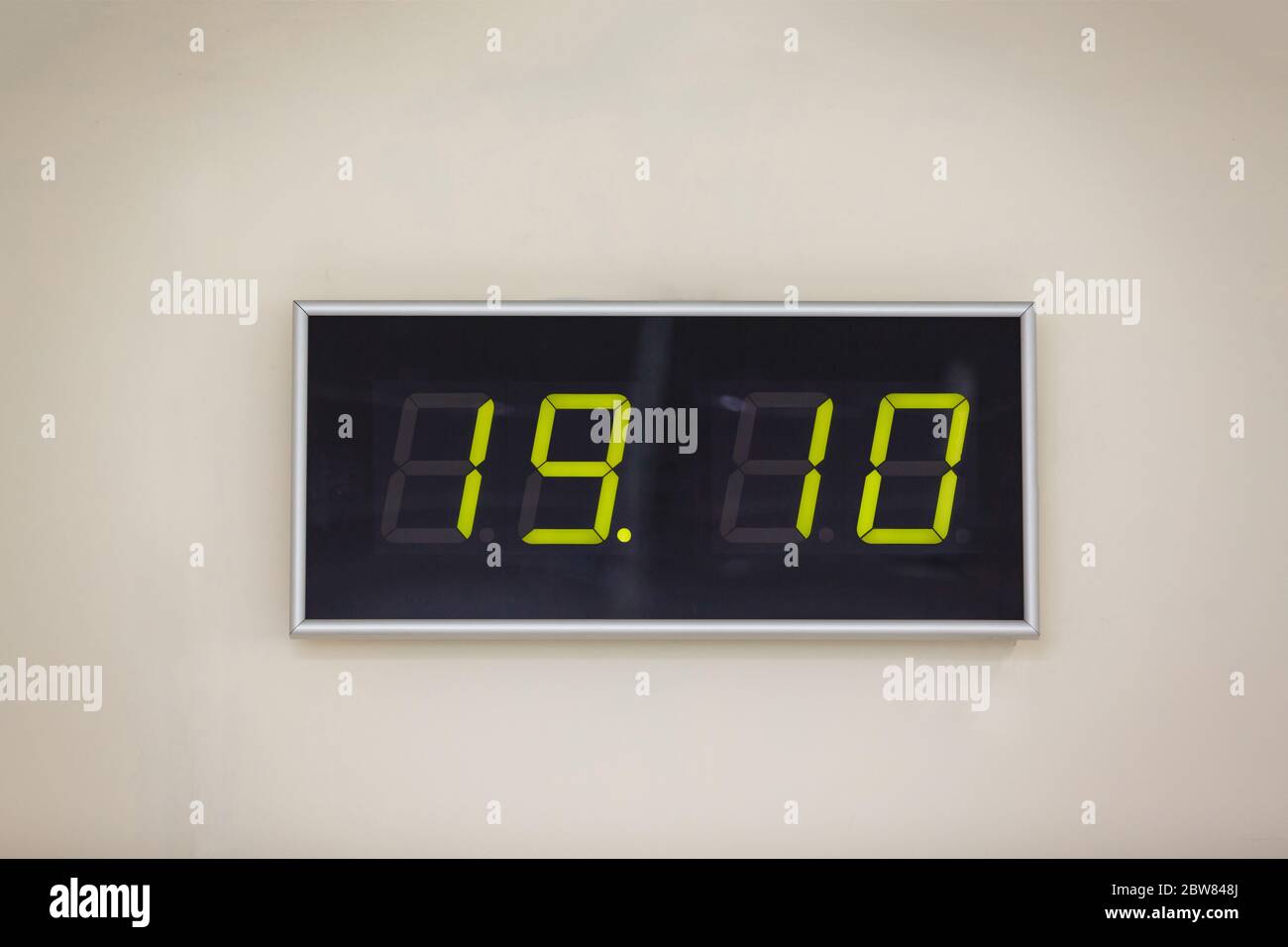 Black digital clock on a white background showing time 19:10 Stock Photo -  Alamy