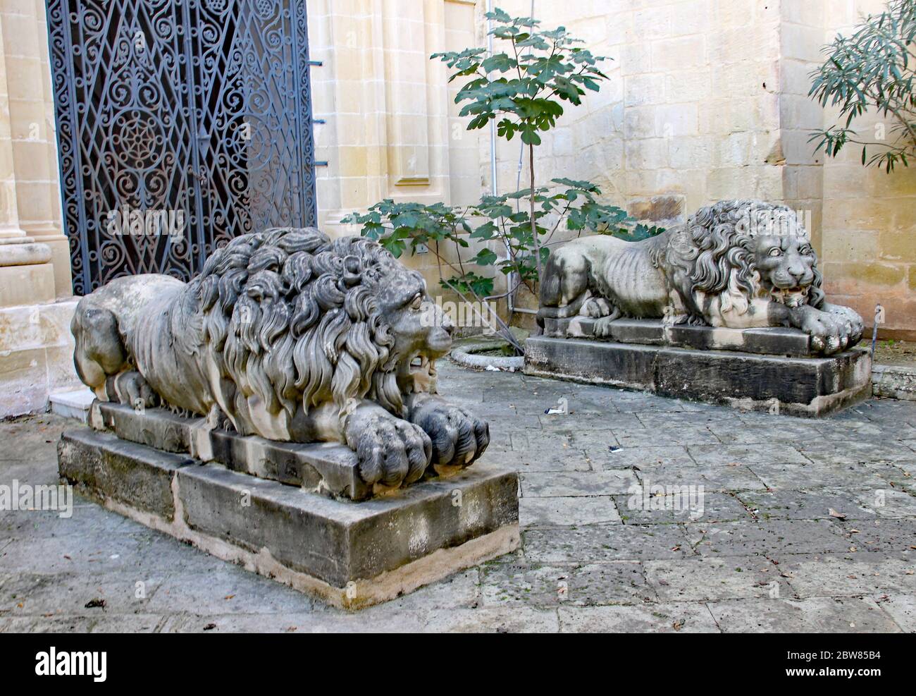 VALLETTA, MALTA- NOVEMBER 16TH 2019: Two lions lay down guarding the gates to the Grand Master's Palace in Valletta Stock Photo