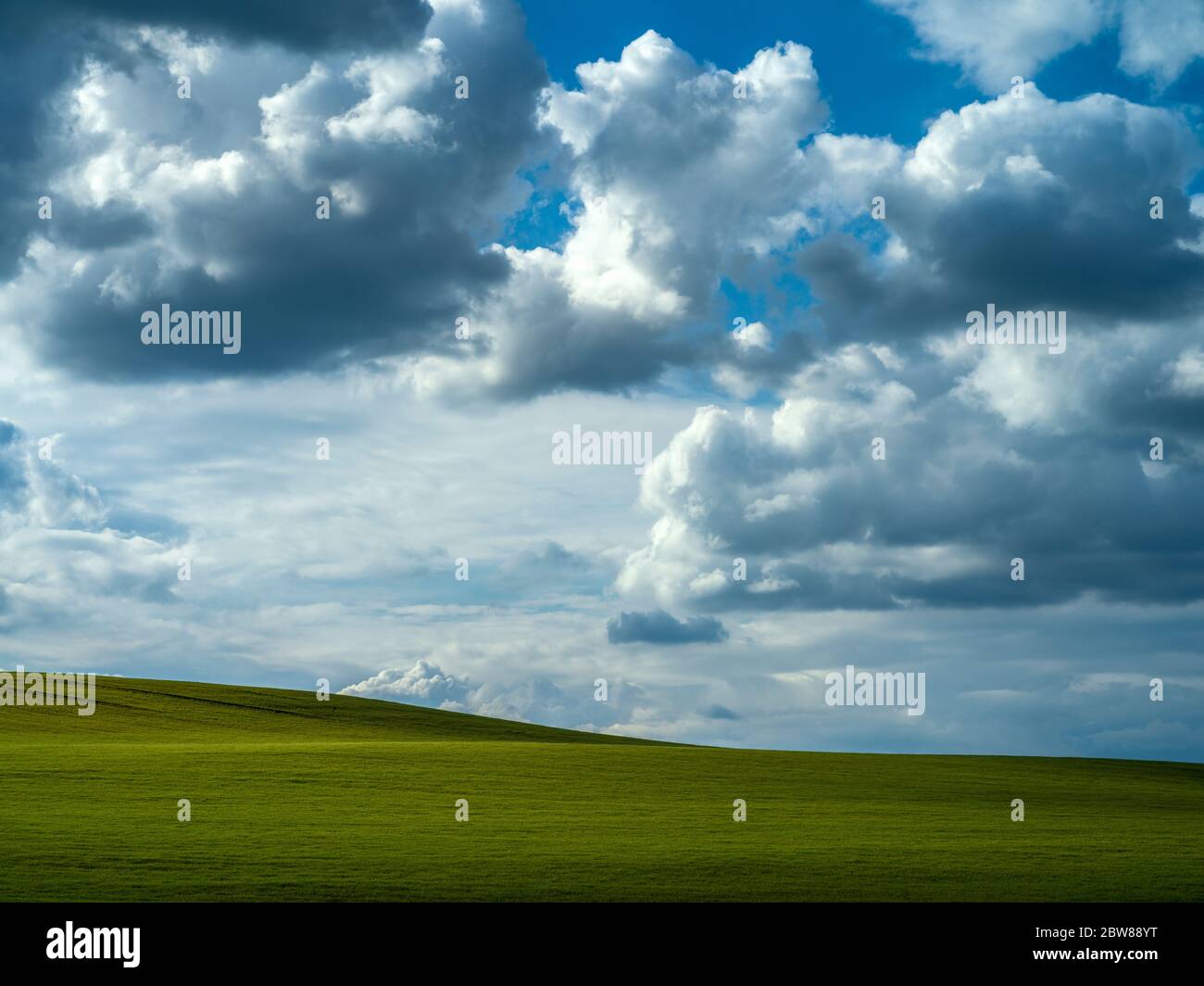 Dramatic sky over a green field Stock Photo