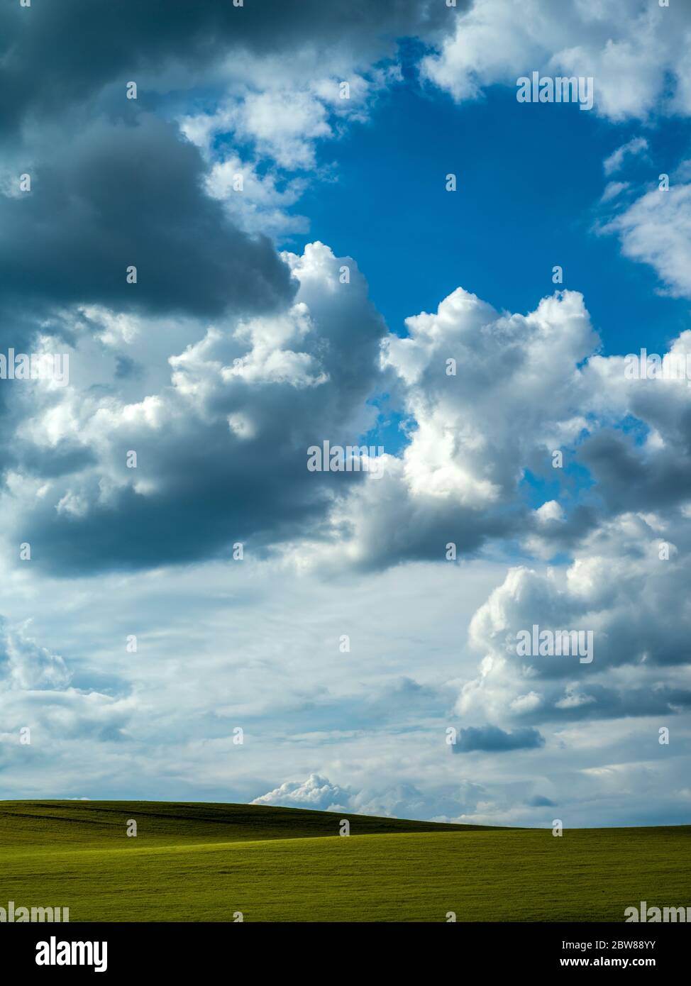 Dramatic sky over a green field Stock Photo