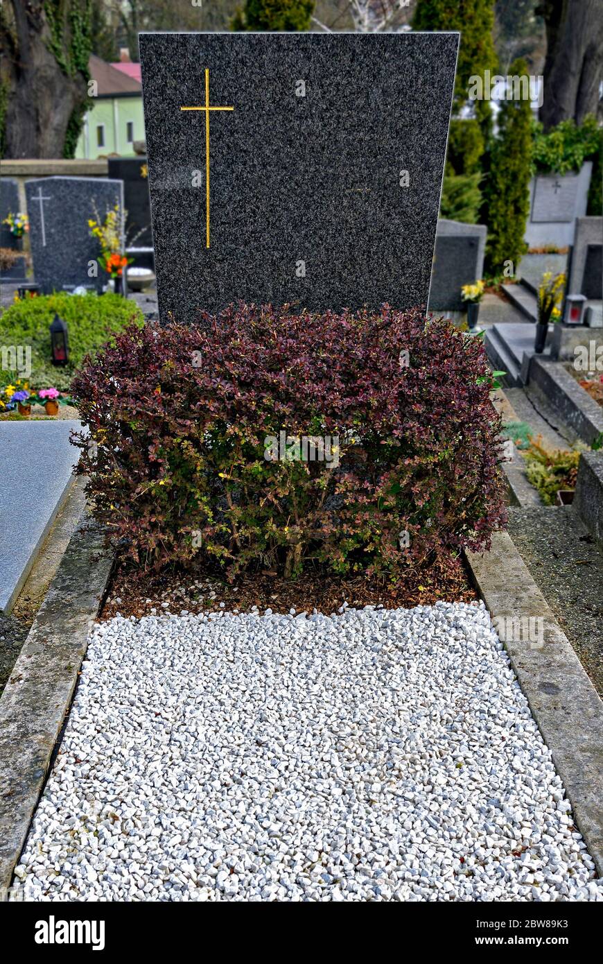 grave with granite tombstone, concrete border and covered with white