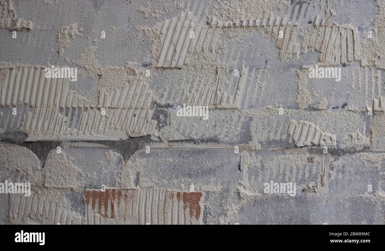 old tile glue or cement . broken wall tiles.wall without tiles Stock