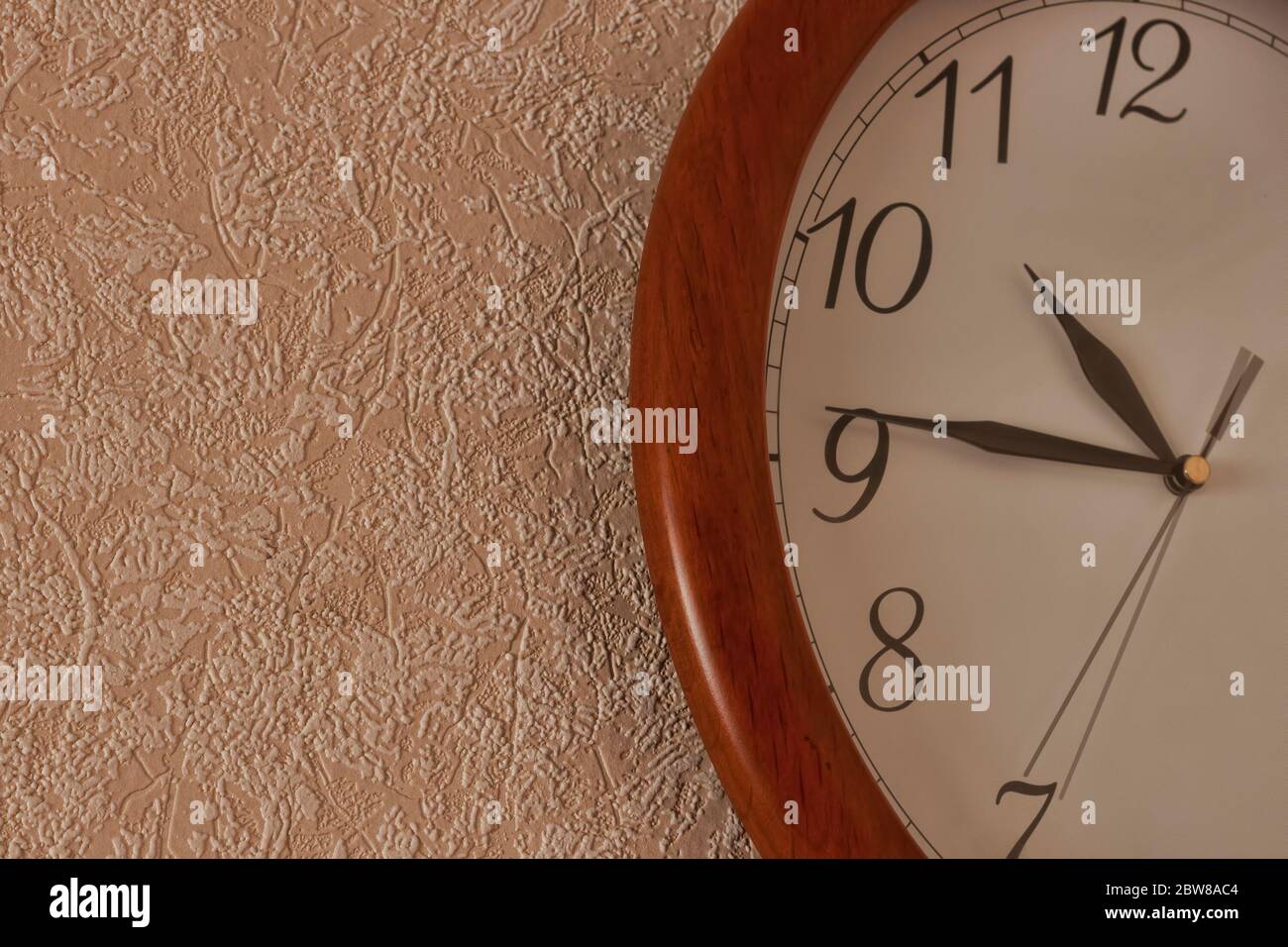 Fragment of the wall clock. Shows the time quarter to eleven Stock