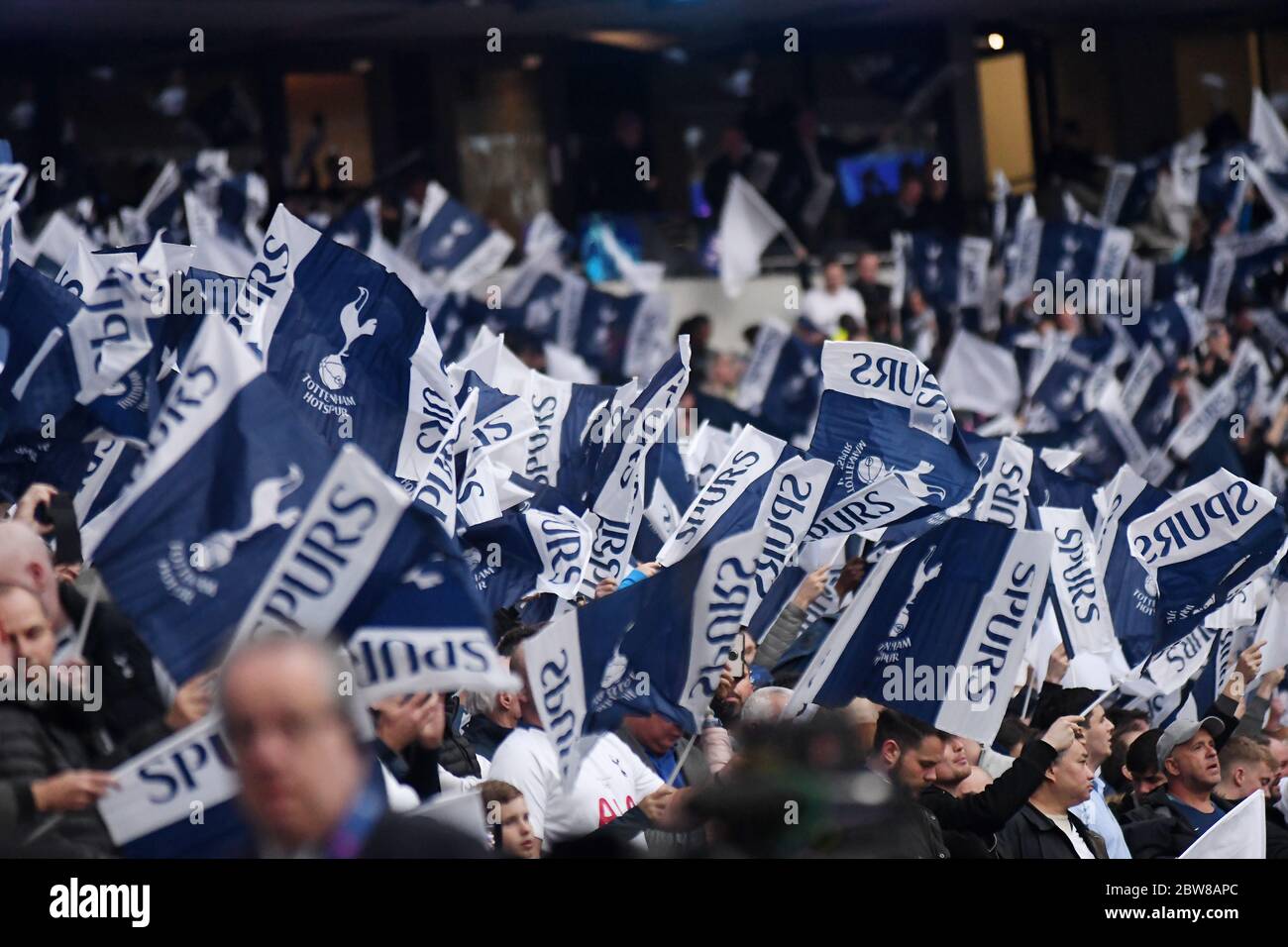 LONDON, ENGLAND - APRIL 30, 2019: Tottenham fans wave flags prior to he first leg of the 2018/19 UEFA Champions League Semi-finals game between Tottenham Hotspur (England) and AFC Ajax (Netherlands) at Tottenham Hotspur Stadium. Stock Photo