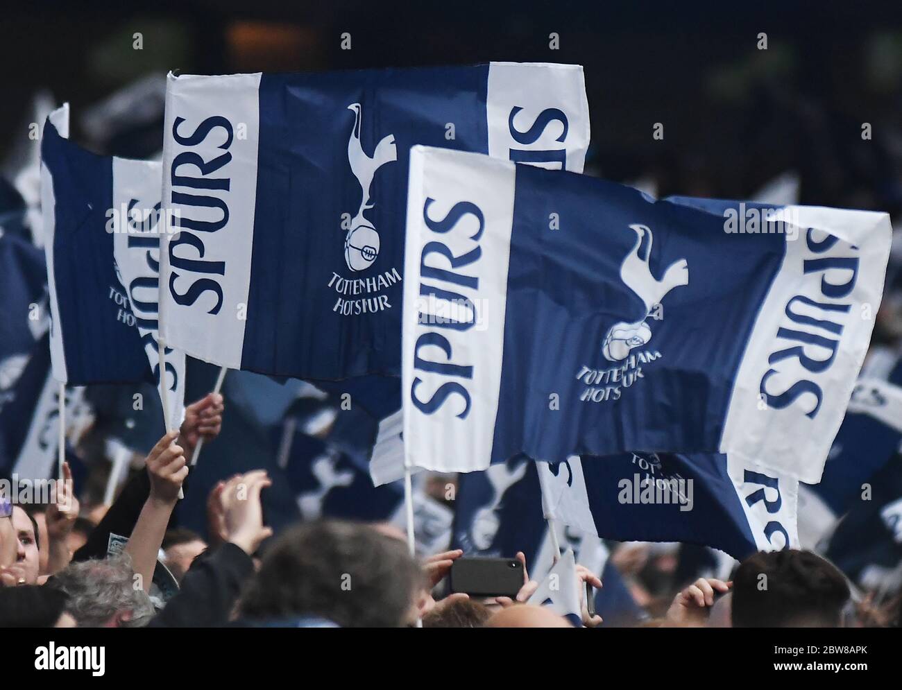 LONDON, ENGLAND - APRIL 30, 2019: Tottenham fans wave flags prior to he first leg of the 2018/19 UEFA Champions League Semi-finals game between Tottenham Hotspur (England) and AFC Ajax (Netherlands) at Tottenham Hotspur Stadium. Stock Photo