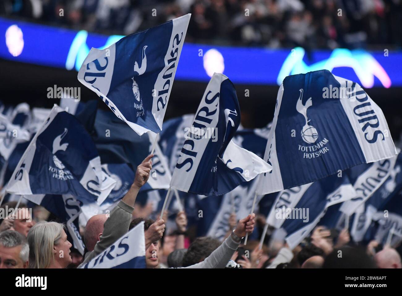 LONDON, ENGLAND - APRIL 30, 2019: Tottenham fans wave flags prior to he first leg of the 2018/19 UEFA Champions League Semi-finals game between Tottenham Hotspur (England) and AFC Ajax (Netherlands) at Tottenham Hotspur Stadium. Stock Photo