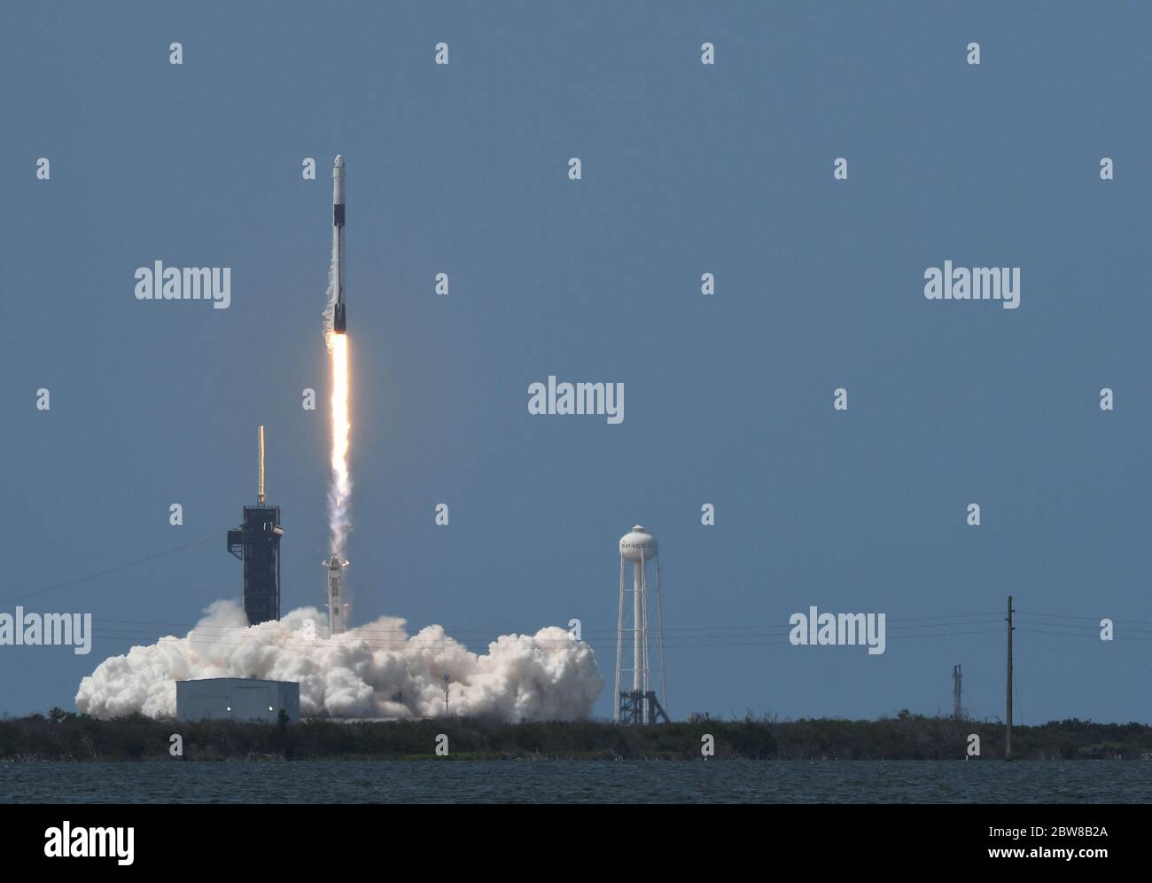 Kennedy Space Center, United States. 30th May, 2020. A SpaceX Falcon 9 rocket lifts off seconds after 3:22 PM with the first manned Crew Dragon spacecraft from Complex 39A at the Kennedy Space Center, Florida on Saturday, May 30, 2020. The mission, classified as Crew Demo 2, is flying NASA Astronauts Doug Hurley and Bob Behnken and is the first manned mission from the Center in over nine years. Credit: Paul Hennessy/Alamy Live News Stock Photo