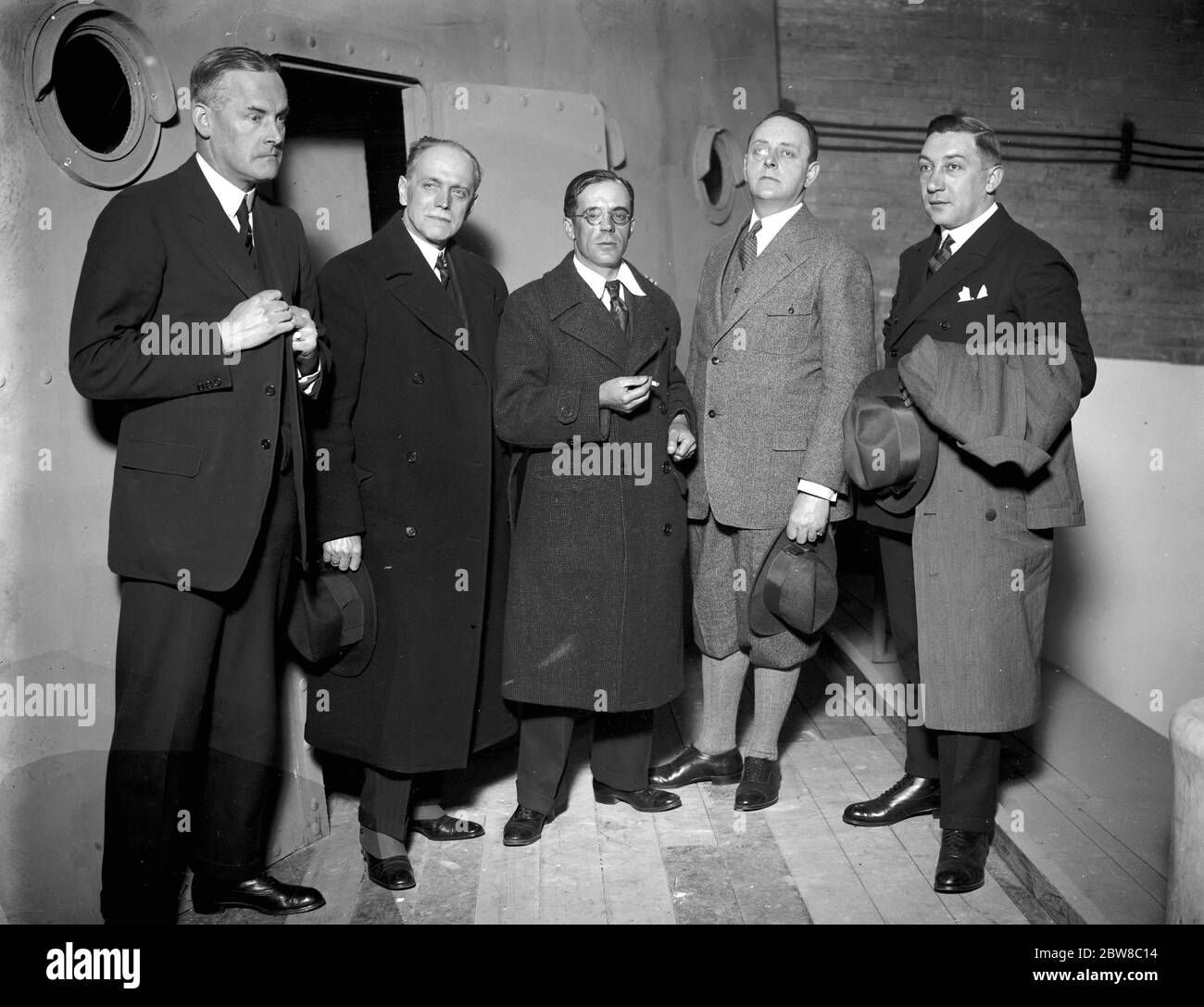 German Naval Actors arrive in London to take part in Coronel and Falkland Islands battle . Left to right , Mr B Wollfe , Managing Director of the British Instructional , Herr Hans Stock , Mr W Summers , producer , Herr R Ludwig , and Herr H Wicher on the quarter deck of the German battleship at Cricklewood Studios . 2 May 1927 Stock Photo