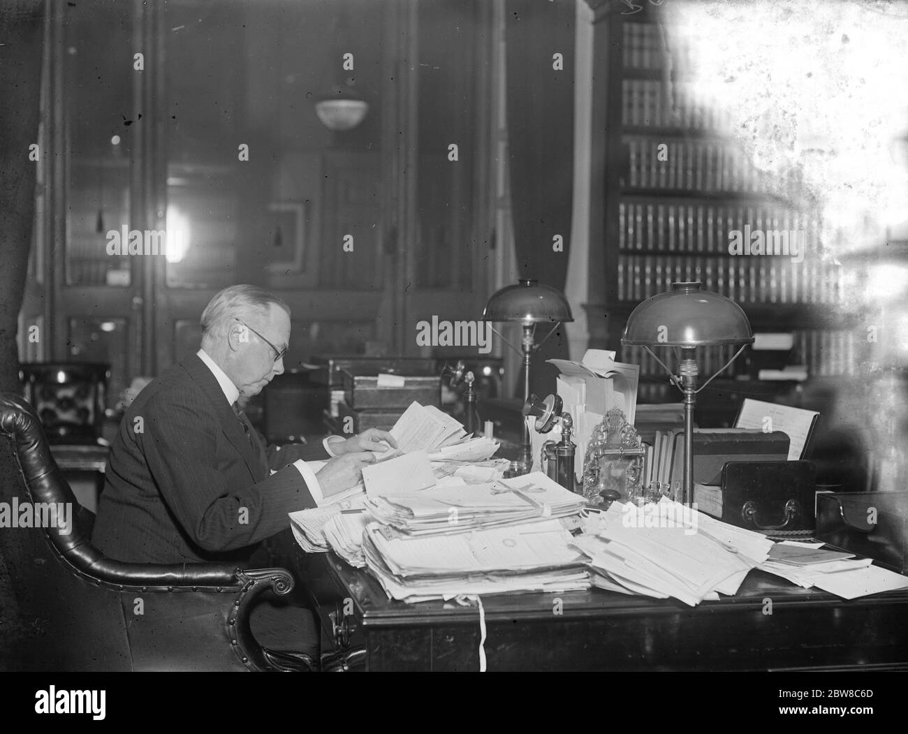 The rejection of the new prayer book : home secretary receives congratulations from all parts of the country . Sir William Joynson Hicks seated at his desk at the Home Office , with the volume of congratulatory correspondence . 16 December 1927 Stock Photo