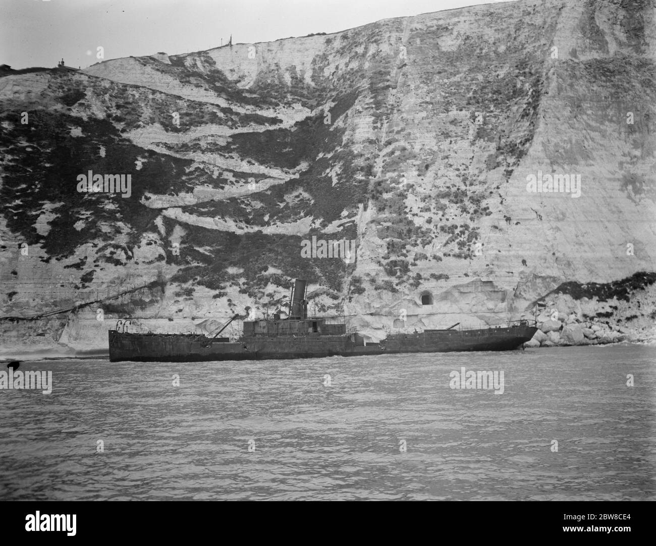 The burning ship Falcon ashore off Dover Harbour . A view of the Falcon from the sea showing Langdon Stairs in background . 25 October 1926 Stock Photo