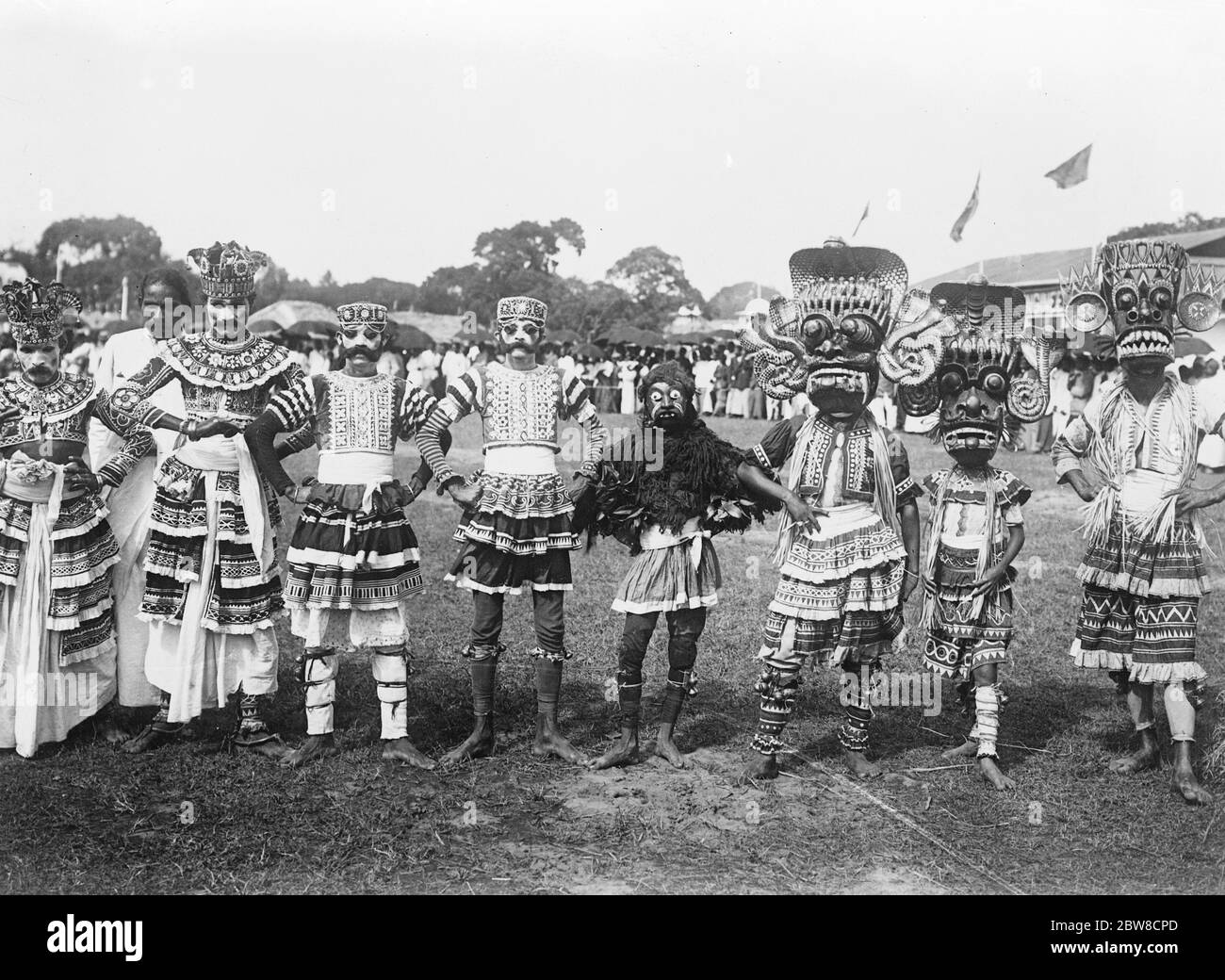 Devil dancers race for charity . An amusing picture from Colombo , where a number of native Devil Dancers raced 100 yards for charity and incidentally a small monetary prize . 8 October 1926 Stock Photo