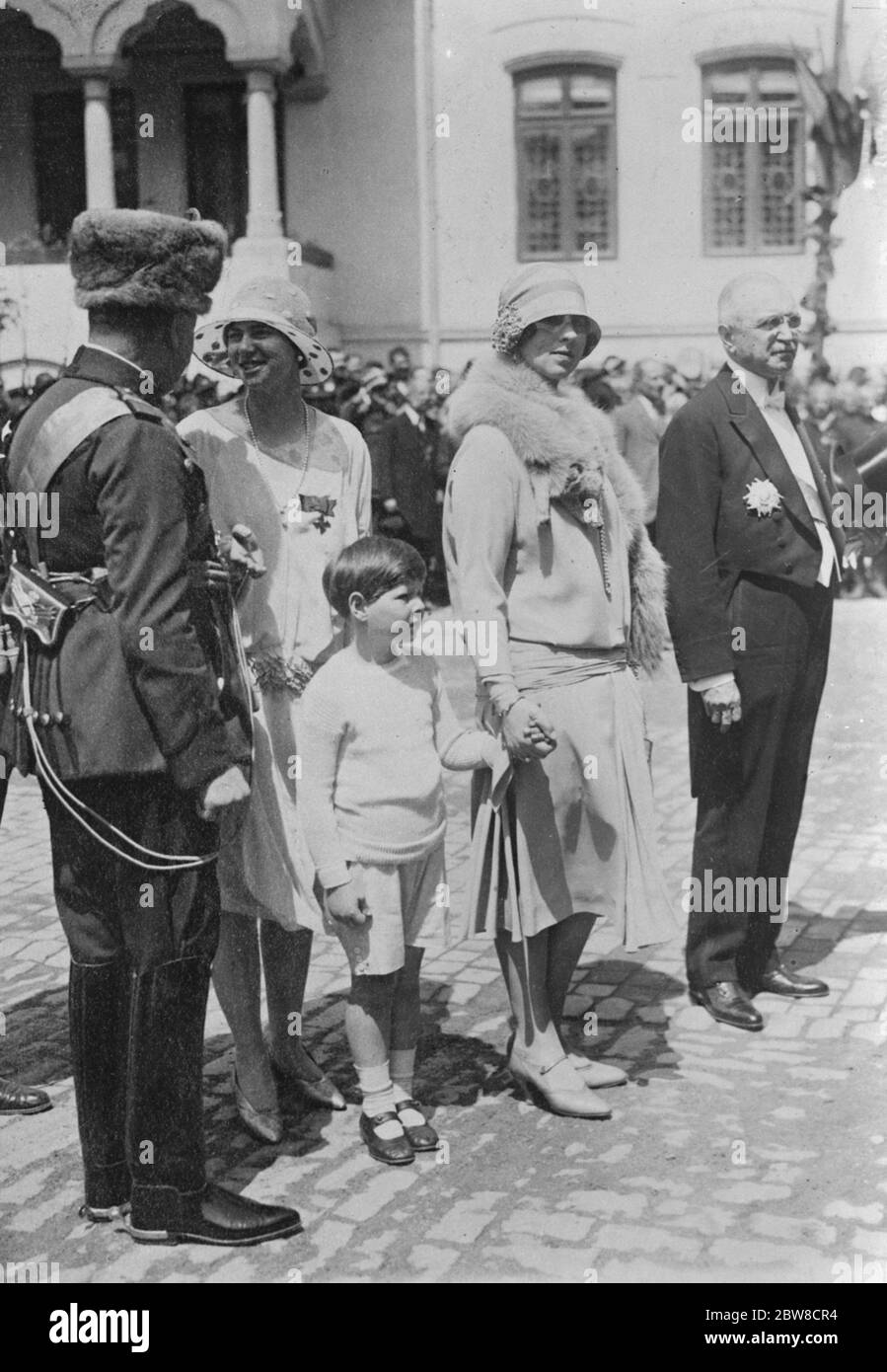 A picture taken last week showing Prince Michael ( now King Michael I ) holding his mother 's hand . On left is Princess Ileana in conversation with General Nikoleanu , Prefect of the Secret Police . On right stands M Buzdugan , President of the Supreme Council of Romania , who has been appointed one of the three Regents . 21 July 1927 Stock Photo