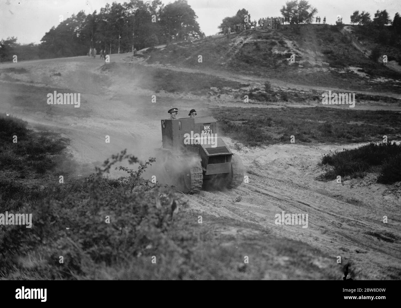 Colonial office conference visitors see war office demonstration of transport cross country vehicles at Aldershot . A two man tank traversing a dusty road . 21 May 1927 Stock Photo