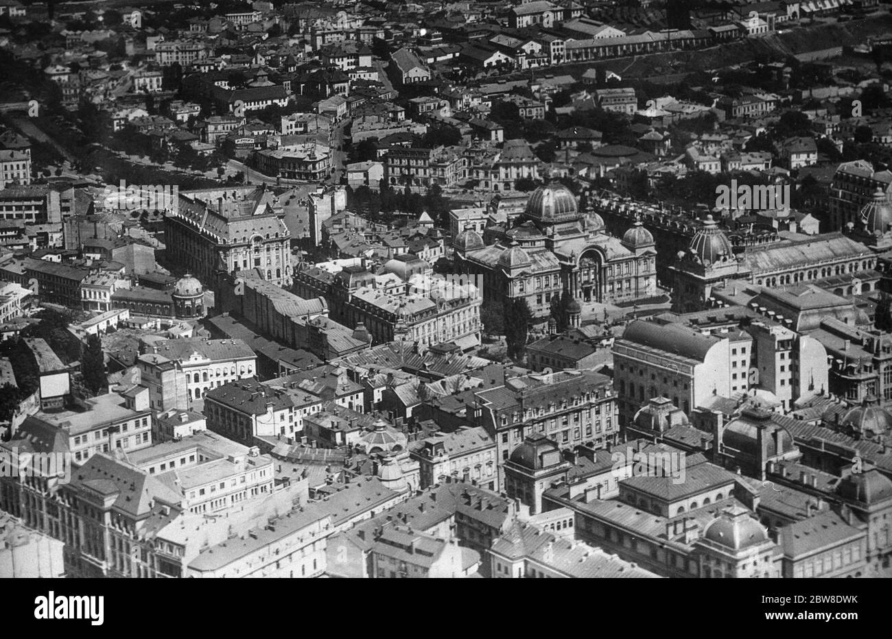 Romania , Bucharest . An aerial view showing the section of the city between the central post office ( left ) and the river Dambovitsa . The large building with the dome , opposite the Post Office , is the National Savings bank . 21 February 1929 Stock Photo