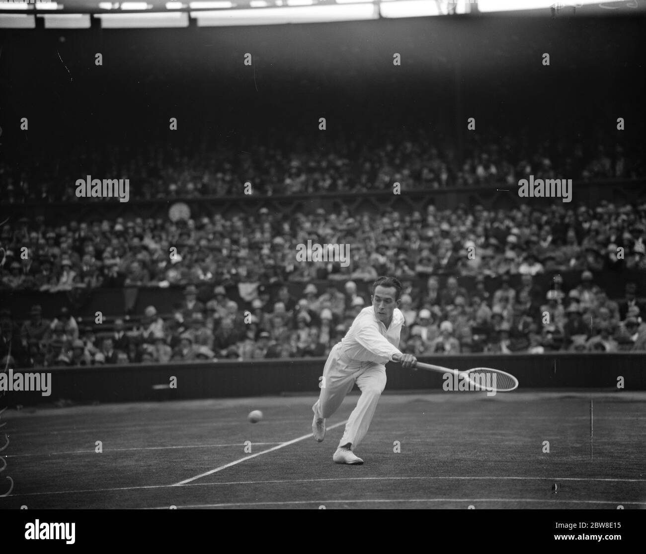 All French final at Wimbledon . Henri Cochet in play against René Lacoste . 6 July 1928 Stock Photo