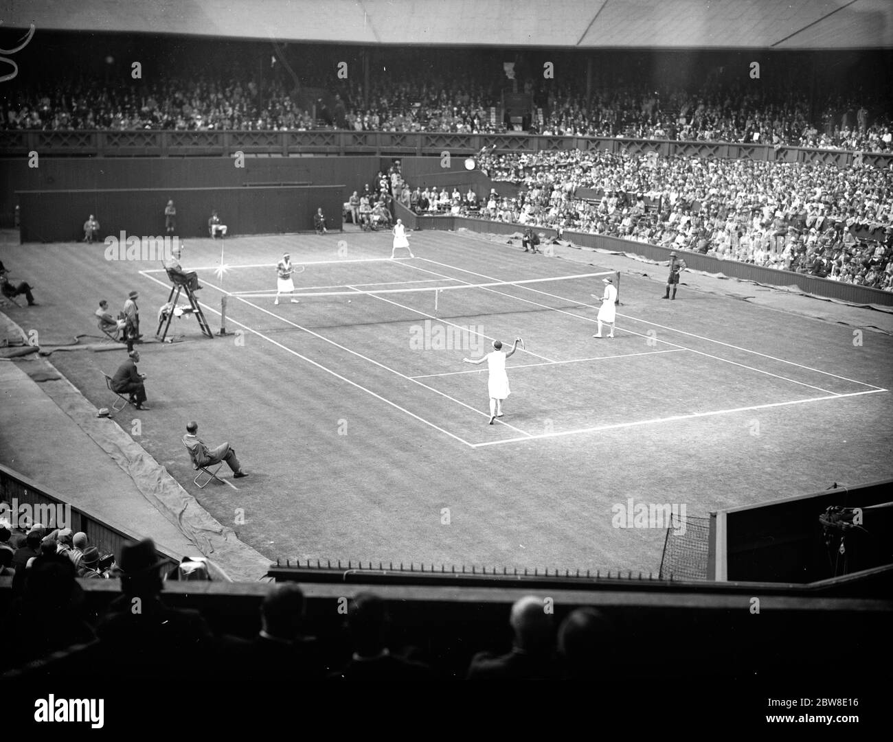 Lawn tennis championships at Wimbledon . A general view during the game between Miss E Ryan and Miss Betty Nuthall , who defeated Mrs John Hill and Miss E L Colyer . 30 June 1929 Stock Photo