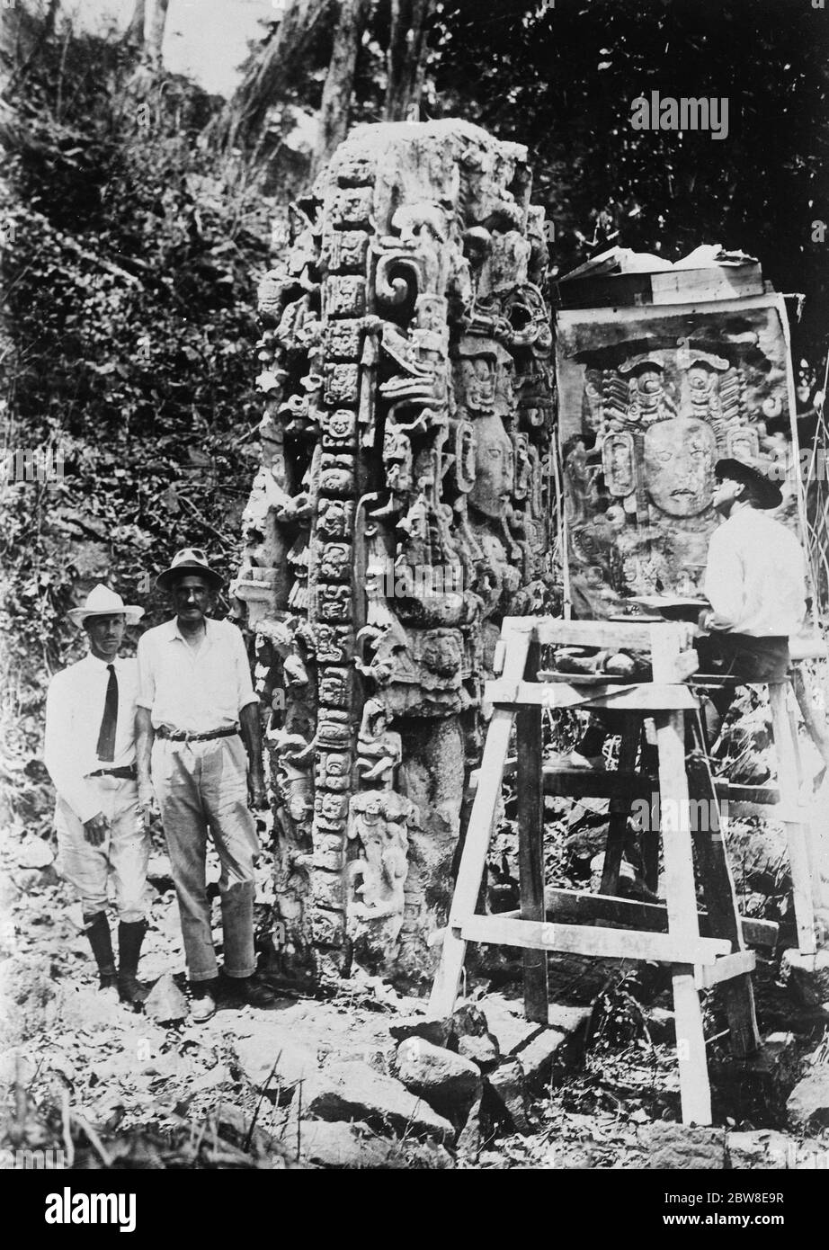 One of the most magnificent Stelae at Copan . The figure of the ruler facing the North is being painted by Mr Joseph Linden Smith , the archaeological artist . To the left is seen the initial series ,9,16,10,0,0, recording the year 501 AD . To the extreme left are Thomas Gann and Dr Sylvanus Morley , of the Carnegie Institution of Washington . On the opposite side of the Stelae is a Great Cycle glyph , or time marker of 8,000 years . 1926 Stock Photo