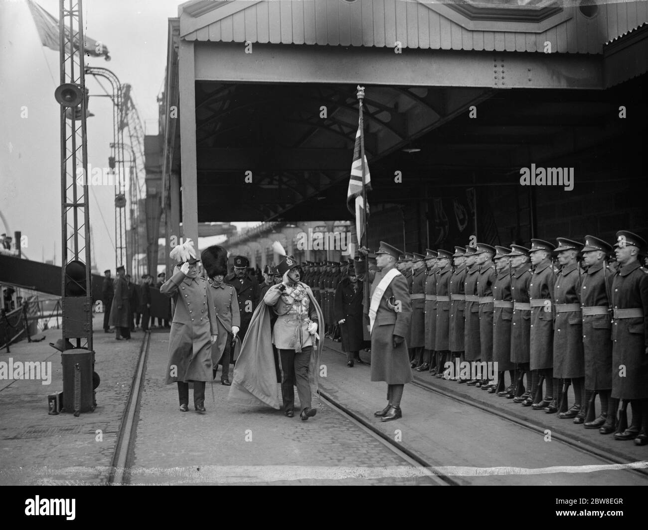 A welcome at the gate of England . King Amanullah of Afghanistan and his beautiful consort Queen Souriya , were welcomed at Dover by the Prince of Wales and a great crowd of Britons who cheered them warmly . The King with the Prince of Wales inspecting the Guard of Honour on arrival at Dover . 13 March 1928 Stock Photo