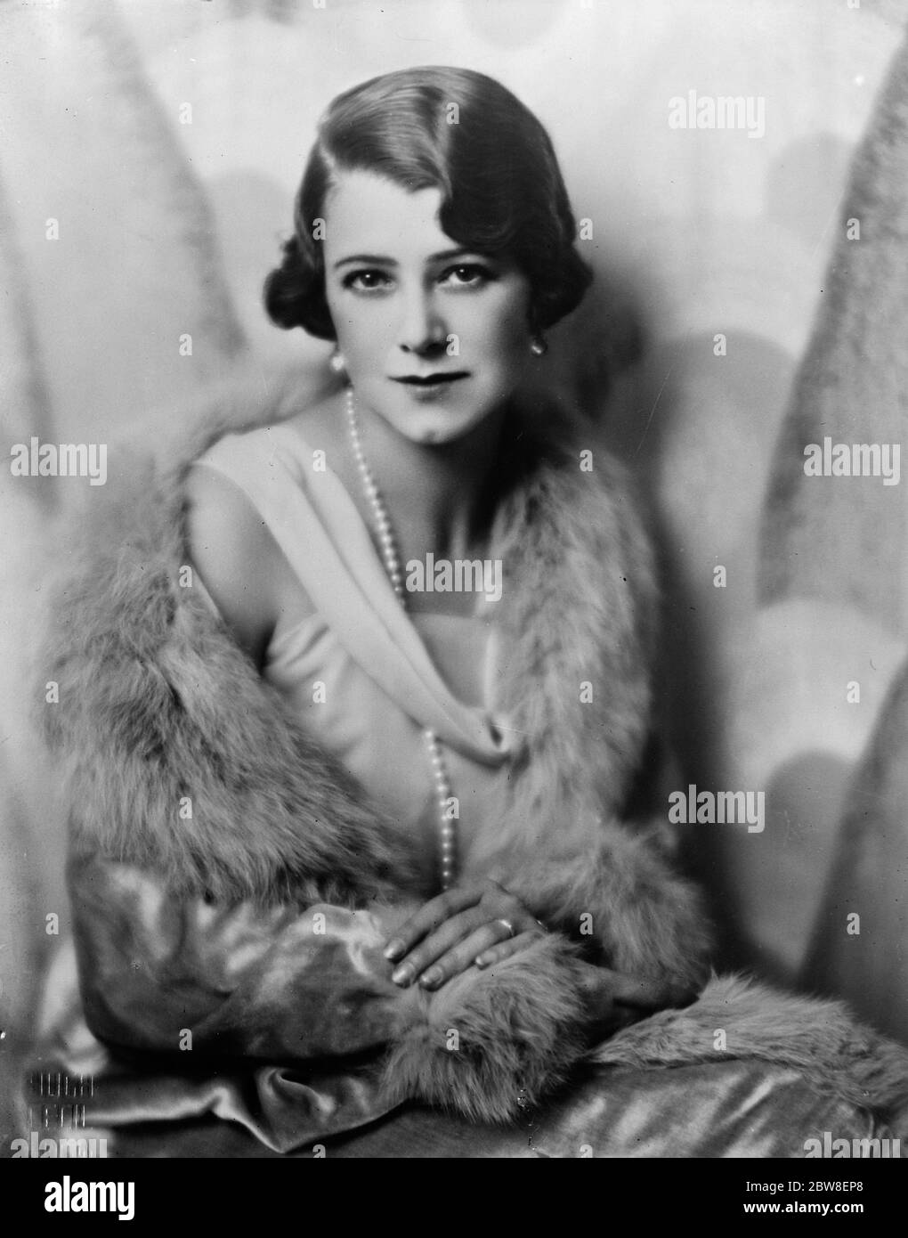 Most eligible bachelor  engaged . Mrs K McNeill , whose engagement to Mr John Dewar , nephew of Lord Dewar , and owner of  Cameronian  , is announced . 8 April 1932 Stock Photo