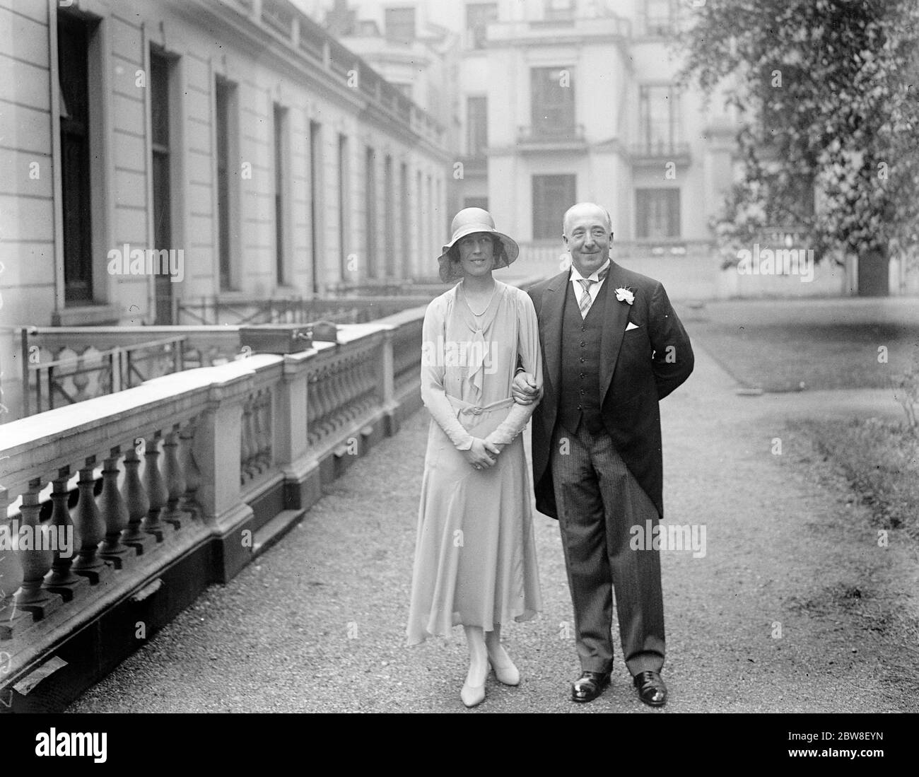 Secret wedding of popular M P . The bride and bridegroom leaving All Saints Church , Ennismore Gardens , after the wedding . Sir John Ganzoni , M P and Miss Gwen Turner . 31 May 1930 Stock Photo