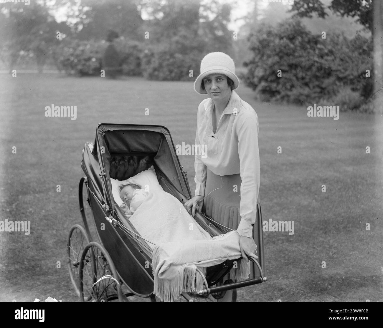 Lord and Lady Cottenhams daughter christened . Lady Cottenham with the baby . The names given to her were Paulina Mary Louise Pepys . 1 August 1930 Stock Photo